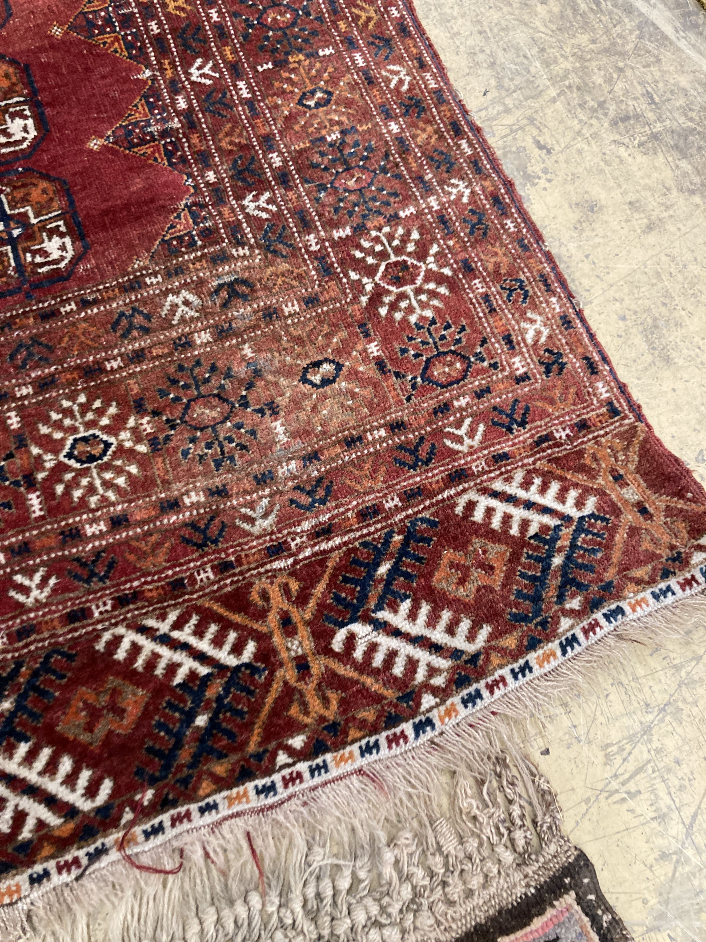 A Bokhara red ground rug, 190 x 114cm